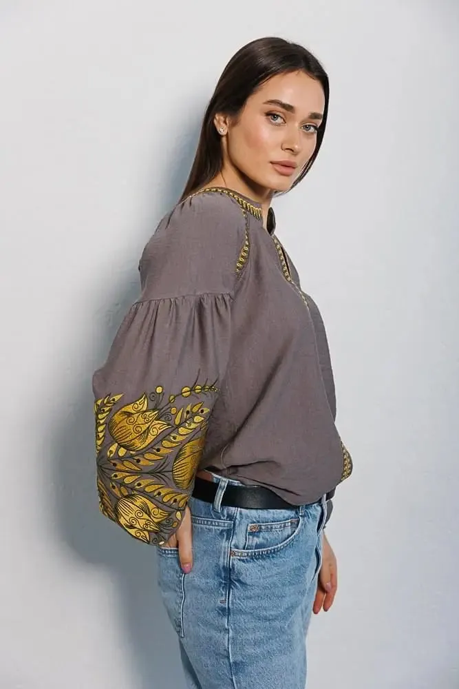 Women's embroidered blouse in graphite color with smooth floral patterns on the sleeves